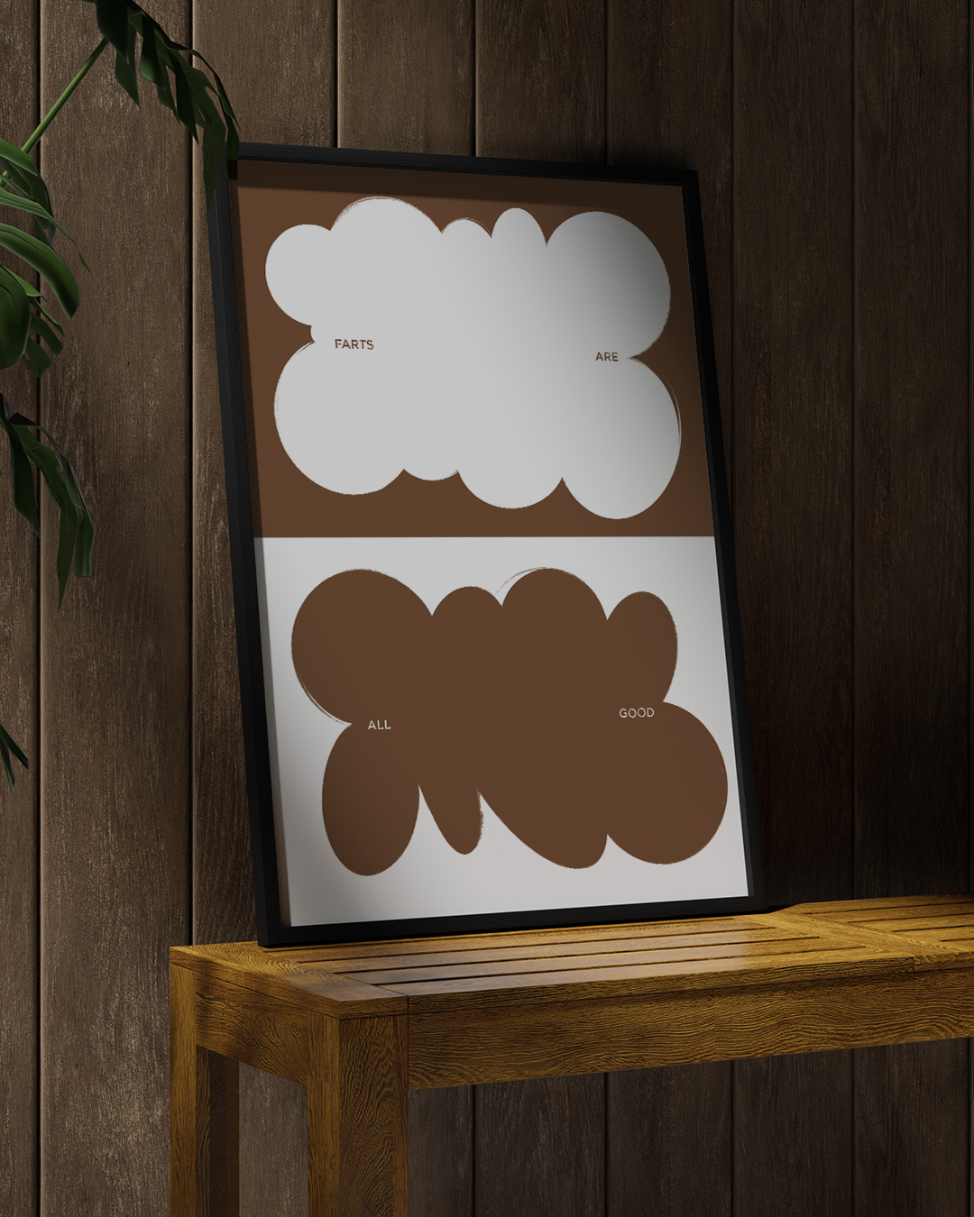 Farts Art Print in white frame, leaning on a timber stool against dark wall