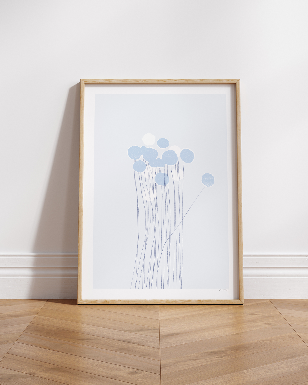 Framed Pom-Pom Art Print in blue tones displayed on wood shelf