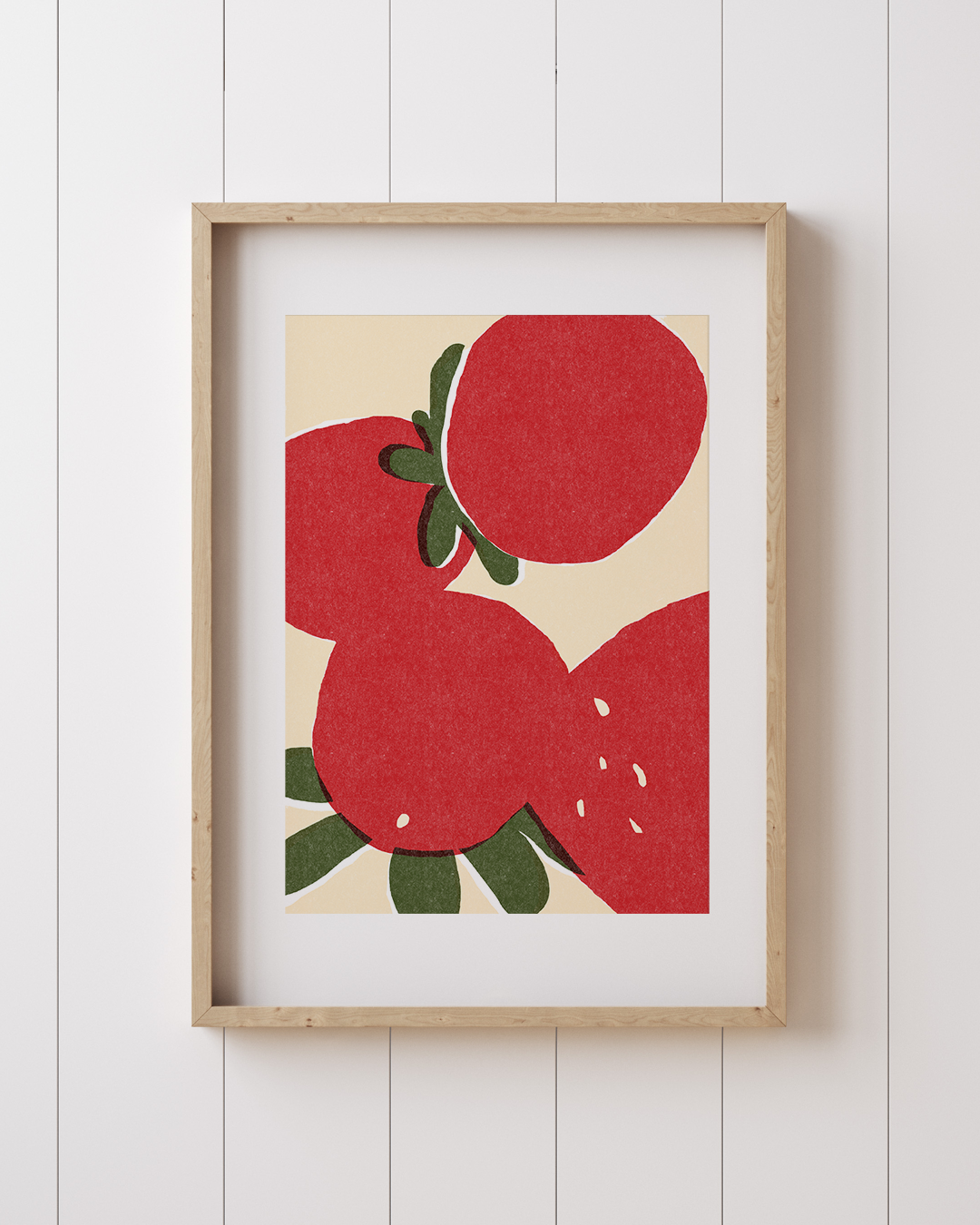 Strawberry artwork framed in white, displayed on a vertical panel wall