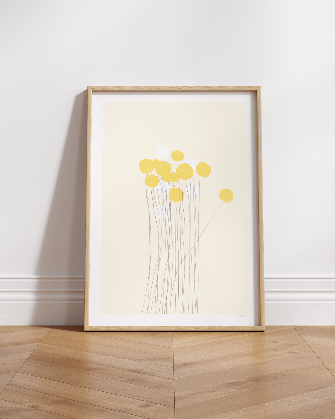 Yellow Pom-Pom artwork framed on a shelf with vertical white panelling